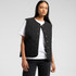 A Quilted Vest in black worn over a white t-shirt, featuring snap buttons and a simple design.