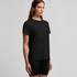 A black t-shirt with a relaxed fit, featured on a model, with a simple design and no visible logos.