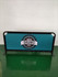 A freestanding café barrier with a teal fabric and a black frame featuring a logo in the centre.