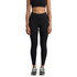 A pair of black seamless leggings worn by a model, paired with a black crop top and athletic shoes.