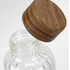 A drink bottle with a clear glass body and a wooden lid, showcasing a modern design.