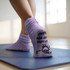 Fluffy Grip Socks in lavender with a textured grip sole, showcased on a person's feet on a yoga mat.