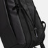 A black backpack featuring zippers and a sleek design. The fabric appears soft to the touch.