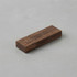 A wooden USB flash drive in a rectangular shape, featuring a brown finish and a simple design.