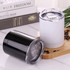 A drinkware set featuring a black and a white mug, both with clear lids, on a marble surface with coffee beans.