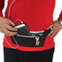 A black waist fitness belt featuring a pocket with a phone and keys, worn by a person in a red top.