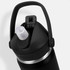 A drink bottle in black with a flip straw lid and a metal base, featuring a carrying handle and a logo.