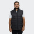 A man wearing a black puffer vest with a high collar and zippered front, featuring side pockets.