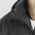 A close-up of a black puffer jacket, featuring a zipped collar and soft fabric texture. The jacket has a logo on it.
