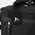 A black canvas cooler bag with a zippered pocket and a tag featuring a logo.