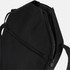 A black bag featuring a zippered compartment and adjustable straps. It has a sleek, minimalist design.