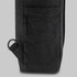 A black Tasman Totepack featuring a textured surface and a side pocket with a loop attachment.