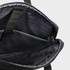 An interior view of a black laptop bag featuring padded compartments and a textured lining.