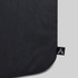A black travel backpack with a smooth texture and a logo tag on a corner.