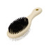 A pet grooming brush with a cream handle and black bristles, featuring a loop for easy hanging.