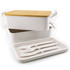 A white lunch box set with a bamboo lid, including an inner container and a tray with white utensils.