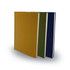A set of three A5 notebooks in mustard, olive green, and navy blue, featuring a smooth cover and a minimalist design.
