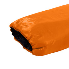 close up top view of a burnt orange shell light weight synthetic sleeping bag quilt with a black interior 