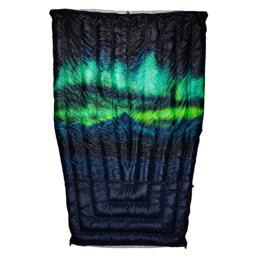 Flat product shot of the Aurora Series camping quilt in navy with a green and teal aurora borealis over a mountain silhouette and starry sky, on a white background."