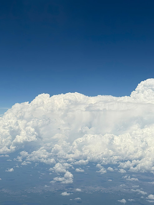 Cloud photography highlighting expansive sky textures and natural light to create serene, visually open corporate interiors.