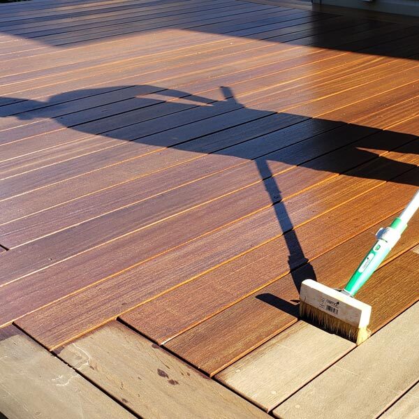 Osmo Decking Oil being applied to deck boards