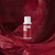 Bottle of Colour Mill Oil Base colour Merlot above sugarpaste coloured in Colour Mill Oil base Merlot
