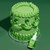 bottle of green colour drops with green cake