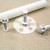 Mini snowflake plunger cutter pressed into thin fondant sheet with cut-out snowflakes and embossed detail visible inside the cutter