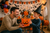 Father and son celebrating with an 8-inch Halloween pumpkin gift basket filled with treats