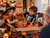 Kids opening an 8-inch Halloween pumpkin gift basket filled with treats during a Halloween family celebration