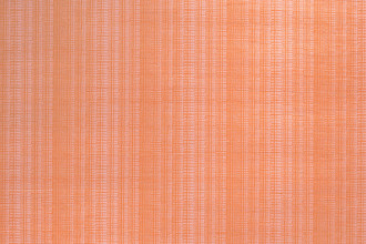 Bark Raffia Wallpaper in Fuchsia – vibrant orange and pink tones on textured surface.