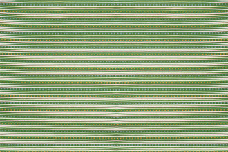 Criss Cross Indoor Woven Fabric in Green, showcasing green tones with stitched yellow and blue crosses and soft grey stripes for a layered, colourful look.