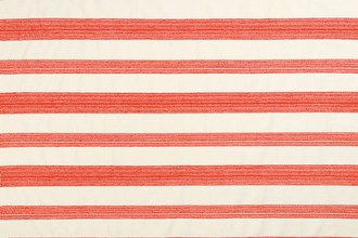 Nomad Woven Fabric in Coral – a bold stripe weave featuring warm coral and natural hues for vibrant yet balanced interiors.
