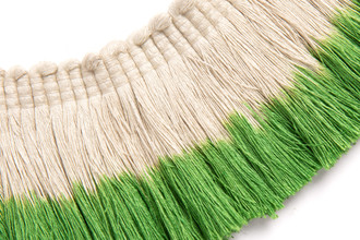 Hand-dyed ombré fringe in a fresh green tone, fading into natural linen for a soft, botanical accent.