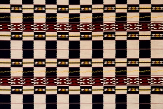 Chubby Check Woven Fabric in Indigo, with deep blue, burgundy, yellow, and natural checks. A bold design for sophisticated upholstery and home decor.