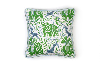 La Jungle Cushion in Green – featuring Raoul Dufy’s blue leopards and elephants among lush green foliage, finished with green and blue Pyramid piping.