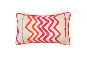 Front view: Hot pink cushion featuring orange and pink zigzag print with embroidered multicoloured striped stitching, finished with woven piping on natural linen.
