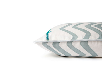 Side detail of the Sage Rick Rack cushion showing teal tonal embroidered stitching and coordinating piping along the edge.