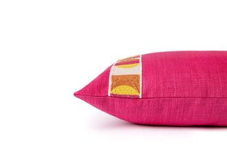 Side view of Pop Art Cushion – highlighting the textured pink, orange, yellow, natural passementerie trim on the hot pink front with plain linen back, 35x60cm.