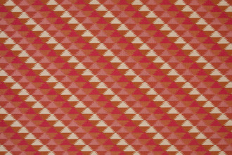 Woven fabric in pinks and reds colours in a geometric pattern