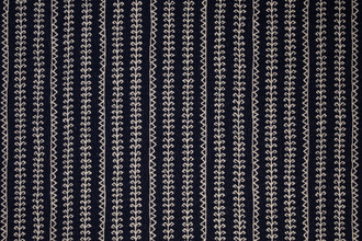Woven fabric in indigo with geometric patterned stripes going vertical