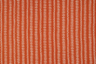 Woven fabric in vibrant orange with geometric patterned stripes going vertical