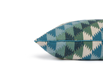 Side view of Busy Lizzie Aqua Cushion – highlighting the lively geometric pattern in tonal blues and greens with a complimentary tailored piped edge, 50x50cm.