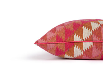 Side view of Busy Lizzie Hot Pink Cushion – showcasing the tonal oranges and pinks with a natural striped band, finished with neat tailored piped edges, 50x50cm.