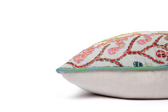 Side View Limited Edition Carnival 28 Cushion in Green colourway featuring soothing blues and greens with a hand-stitched pomegranate floral and leaf design, adding an artistic touch to your décor.