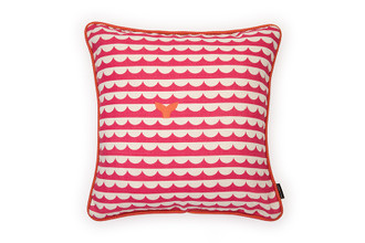 Front view: Hot Pink cushion with bold waves and whale's tails design featuring circus hot pink and orange piping.