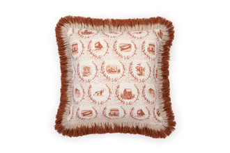 Front view of the Set the Scene cushion in terracotta with playful terracotta ombre fringe trim, featuring a modern twist on a classic toile design.