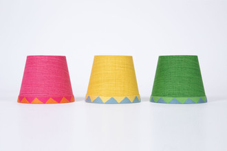 Row of all colours available of the Soprano Circus Lampshades with Big Top Tap Trim.