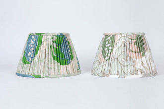 Side-by-side view of the 14” Carnival Green and Carnival Olive pleated lampshades, showing both colourways with ecru and natural linen linings.