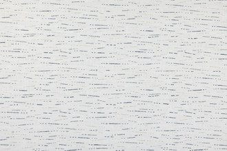 Drizzle upholstery fabric from the Nendo Collection in indigo. A rain-inspired abstract linen design woven with speckled texture for depth and movement on a neutral base.